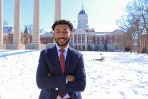 Bryson Ferguson posing for a picture in front of the Mizzou Columns.