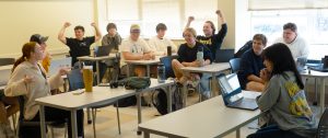 Several students celebrating in a classroom.