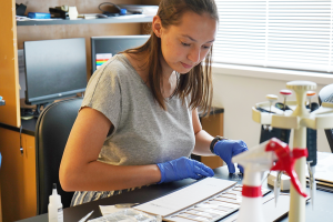 Audrey Shively working in a lab on a research task.