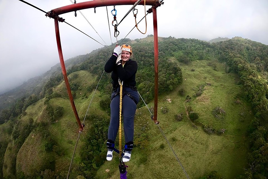 An individual smiling at the camera while participating in an activity.