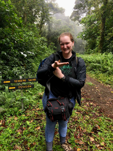 Bailey Stover smiling for the camera in a forest.