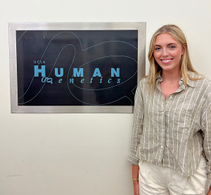 Brooke Bowman posing for a photo in front of a sign.