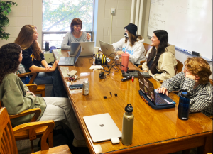 A group of students and a professor working together on a project.