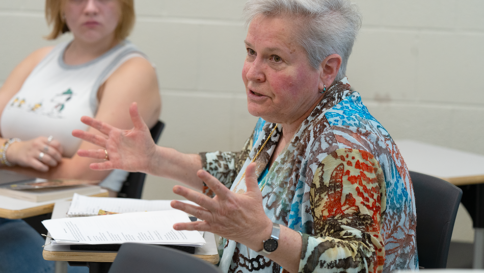 Julie Rosenfeld sitting down and speaking to students.