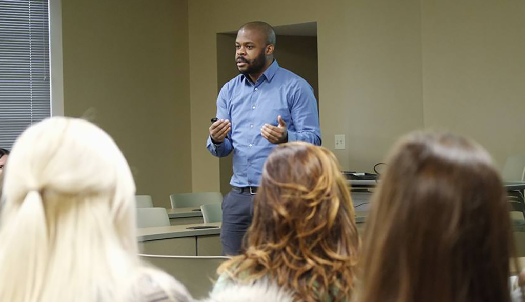 Julius Riles teaching to a classroom full of students.