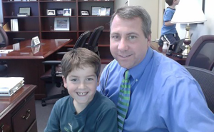 Christopher Daubert smiles for a picture with his son, Maxwell Daubert.