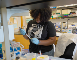 Michelle Woolridge in a lab performing a research task.