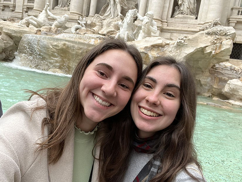 Two students posing for a picture while smiling.