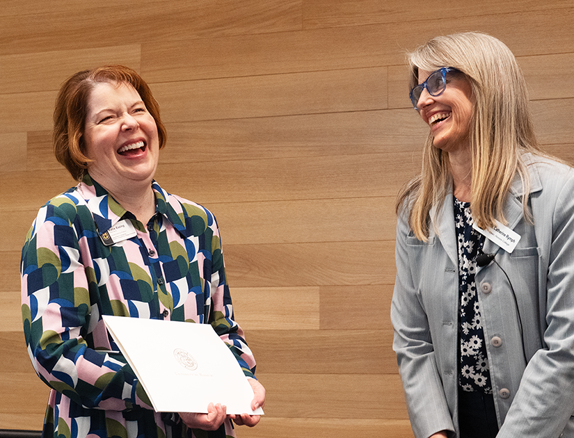 Katie Essing, pictured on the left, laughs after receiving an award from Catherine Rymph.