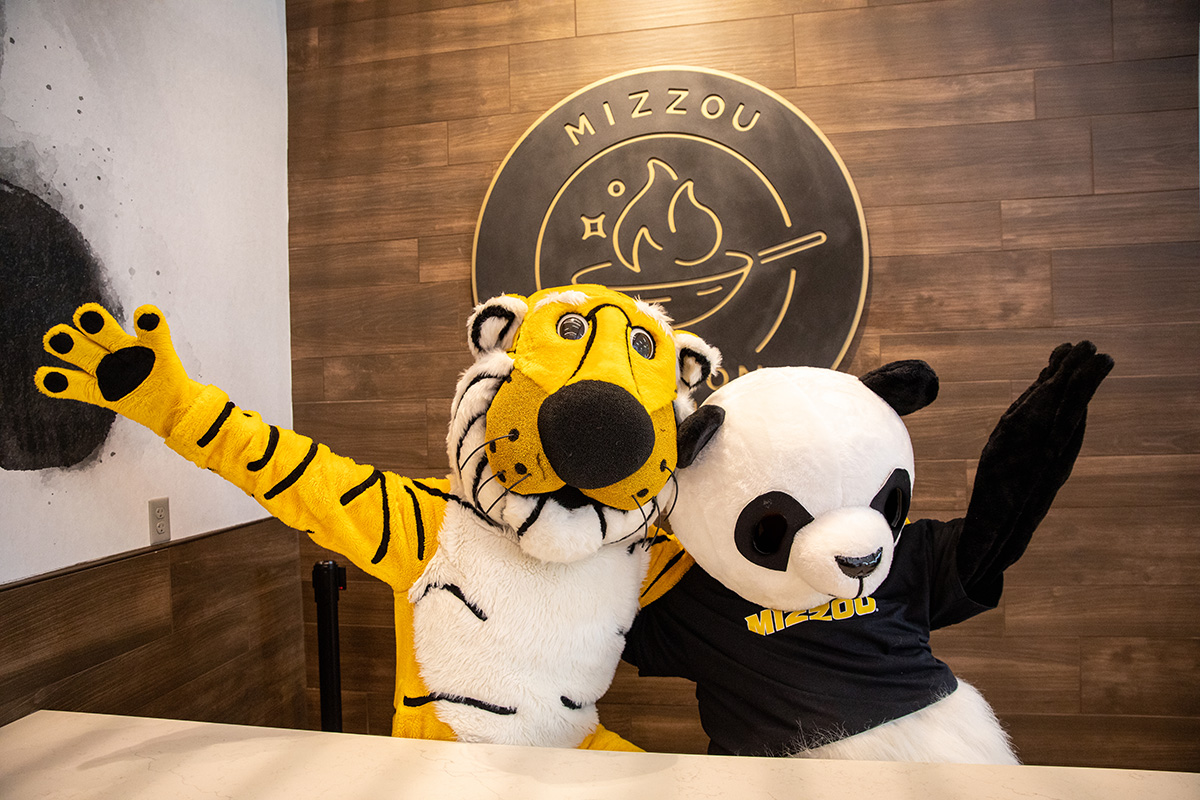 Mizzou's mascot, Truman the Tiger, poses for the picture with a panda mascot from Panda Express for a picture.