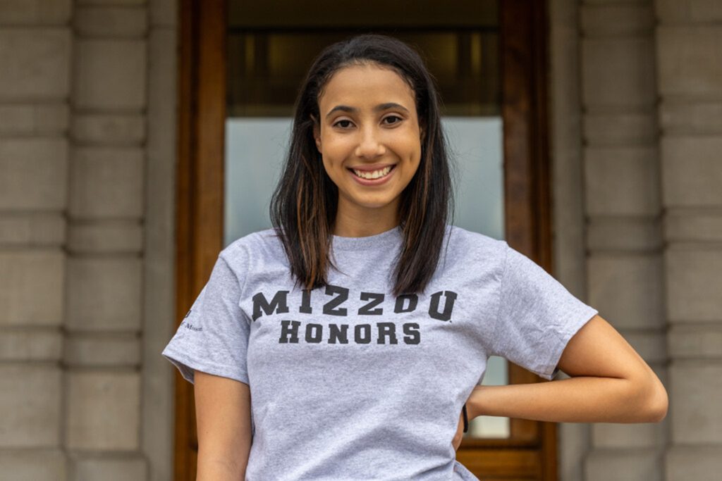 Olivia Gyapong smiling for a photo while wearing a Mizzou Honors t-shirt.