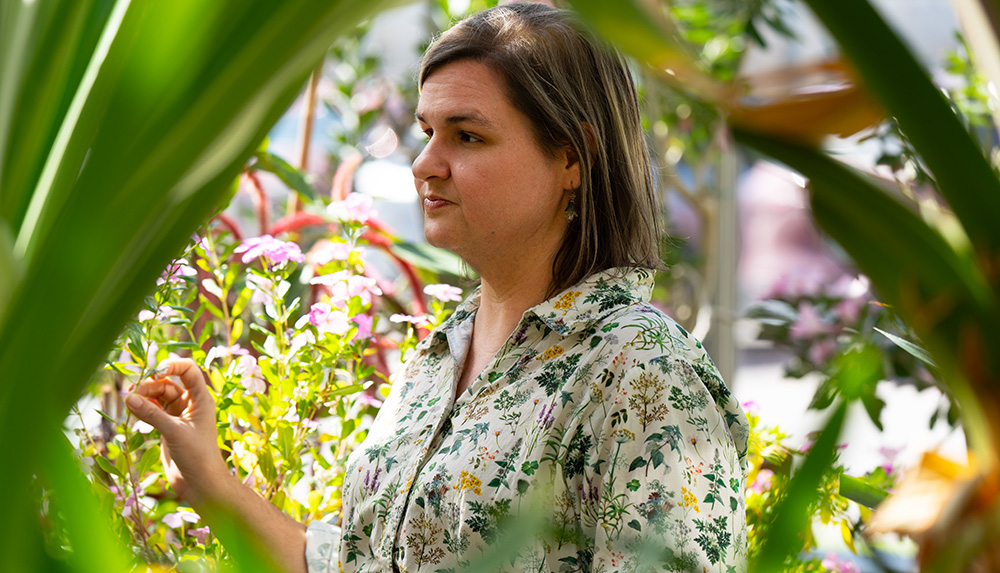 Amanda Durbak standing among plants while teaching.