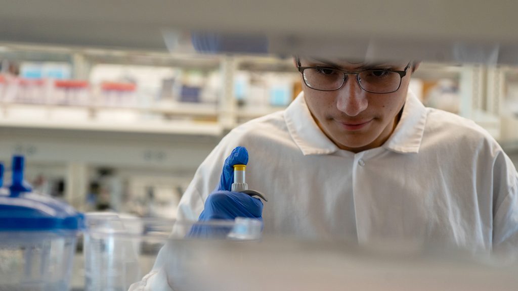 Blake Arciga conducting research in a laboratory.