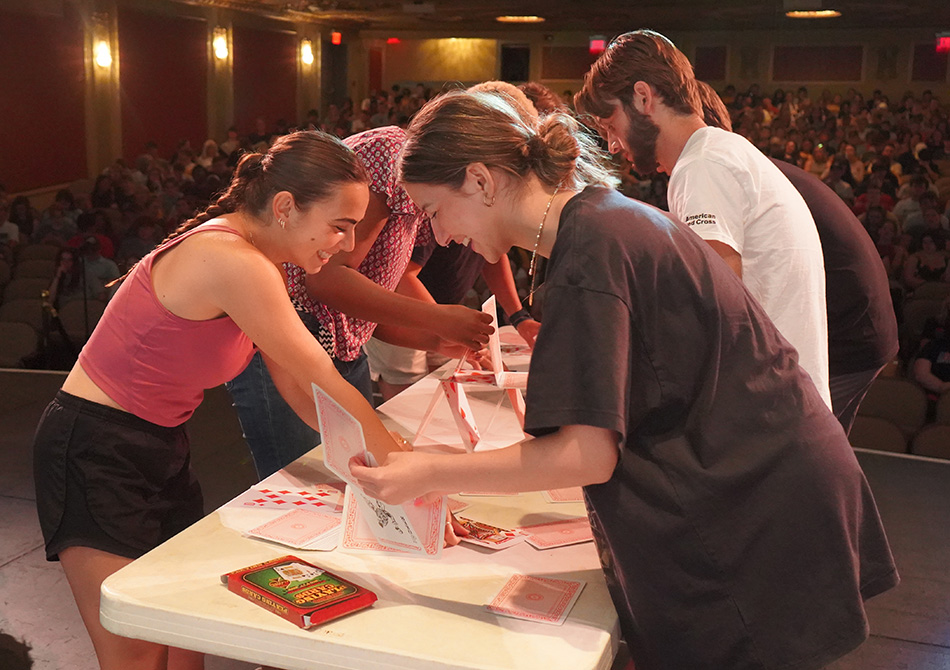 A group of students playing a card game.