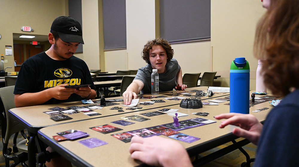 A group of students playing a card game.