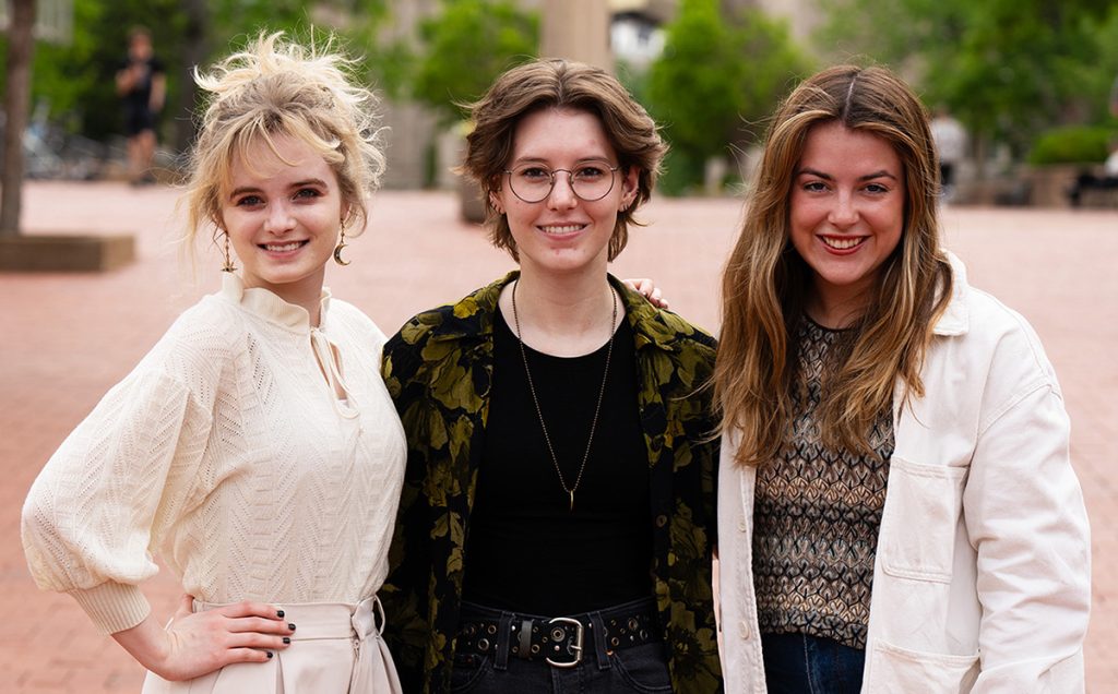 MJ Montgomery, Olivia Anderson and Maggie Courtney smiling at the camera for a photo.