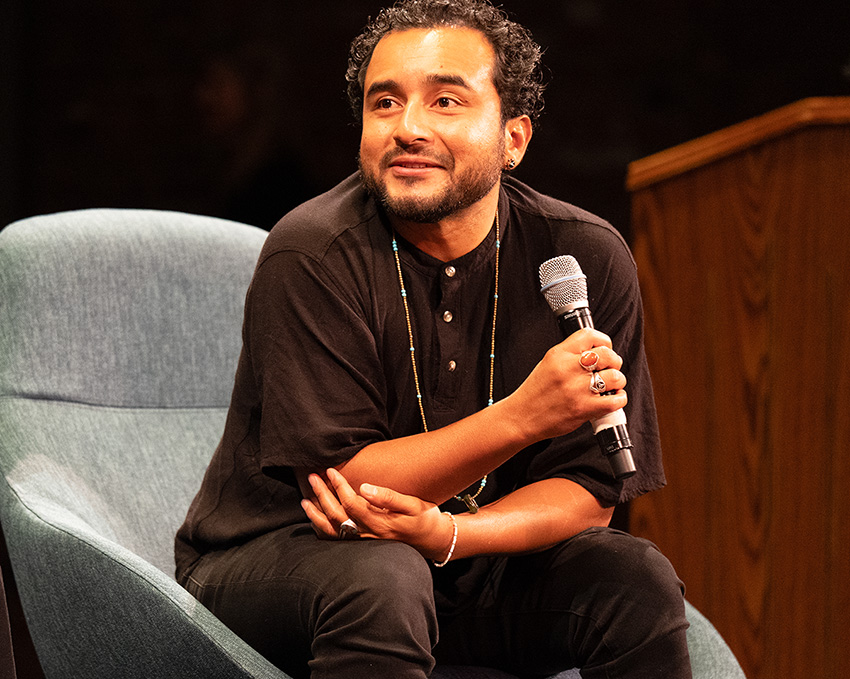 Javier Zamora talking to an individual during an interview.