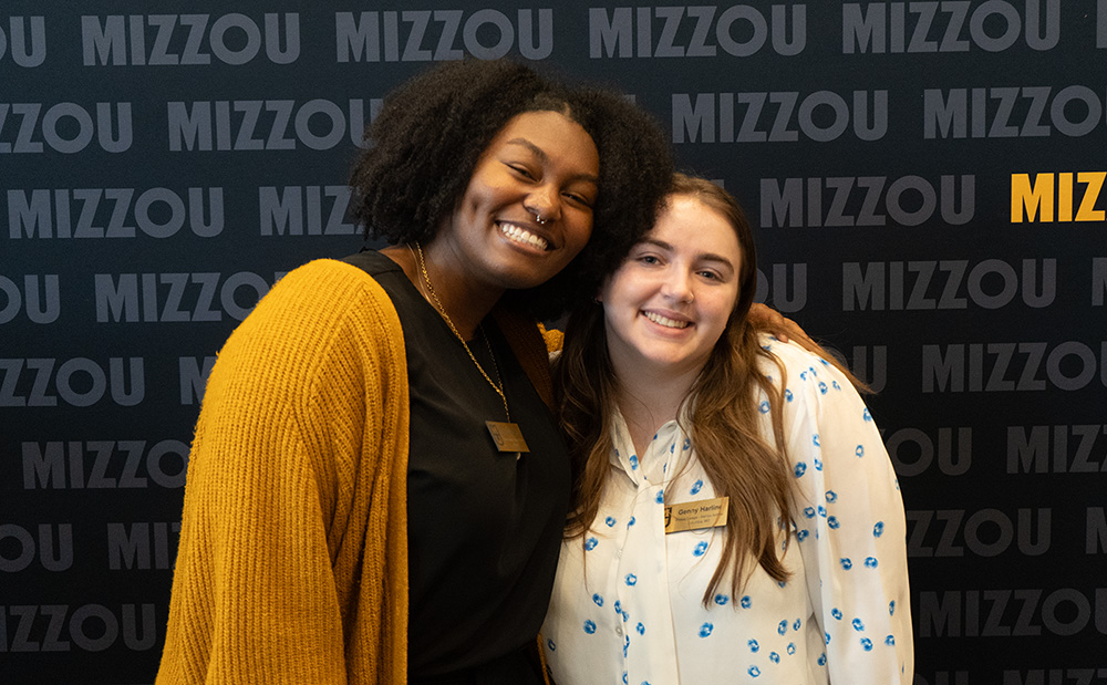 Two students smiling for a picture.