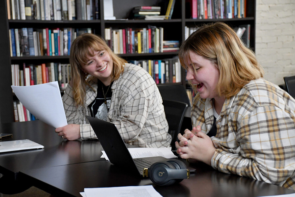 Two students laughing while in class.