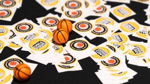 A photo of several stickers and tiny basketballs.