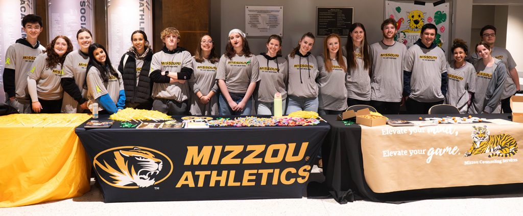 A group photo of numerous students standing and smiling.