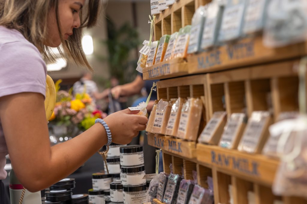 An individual looking at a variety of farmer's market options.