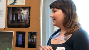 Ever Cole smiling while presenting her research.