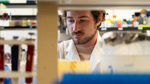 Nick Ice performing a research task in a laboratory.