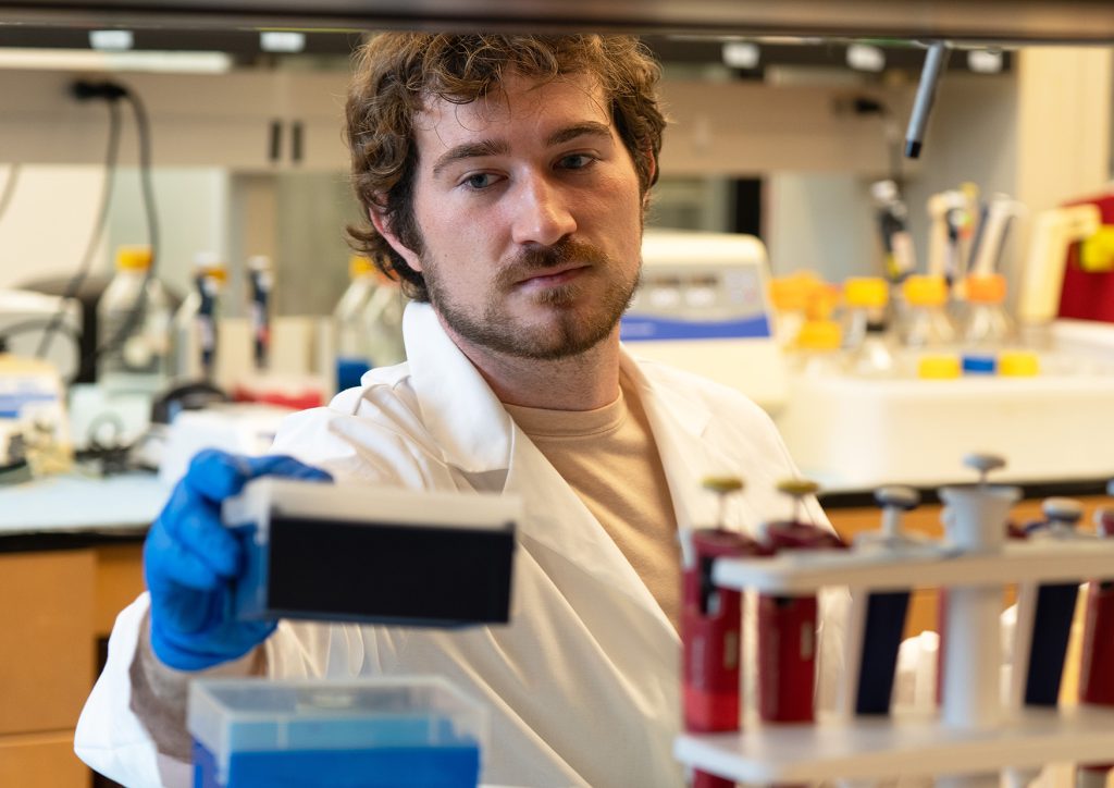 Nick Ice performing a research task in a laboratory.