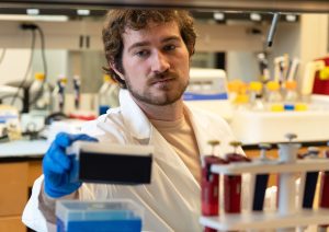 Nick Ice performing a research task in a laboratory.