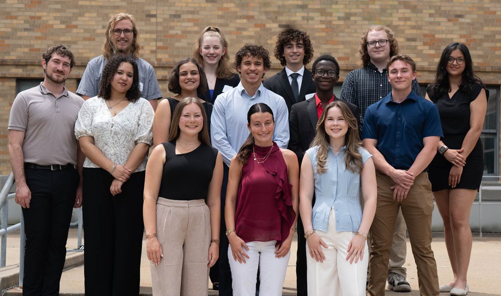 A group of several students smiling while posing for a photo.