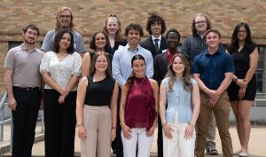 A group of several students smiling while posing for a photo.