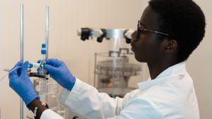 Joseph Oyewsui performing a research task in a laboratory.