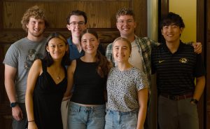 A group of several students smiling while posing for a photo.