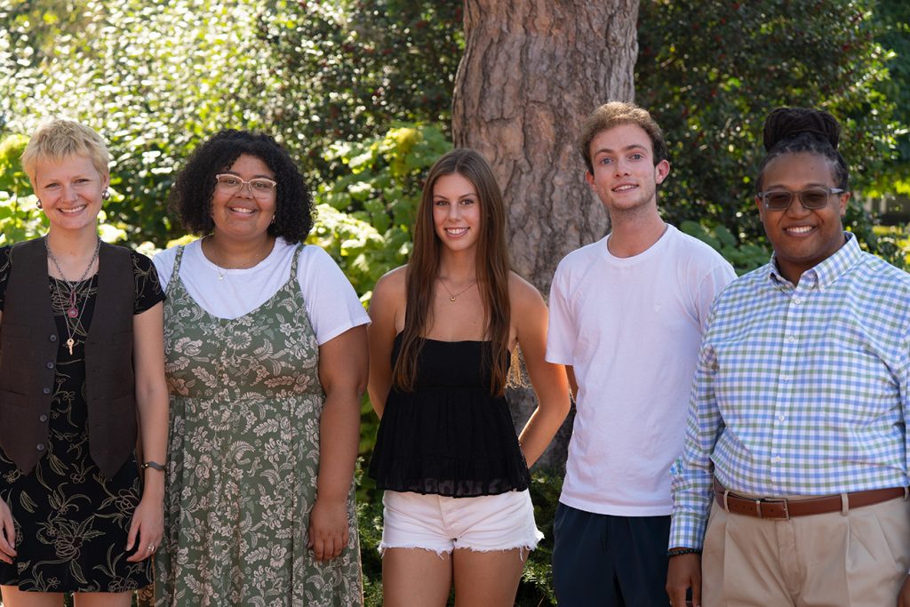 A group of students smiling while posing for a picture.