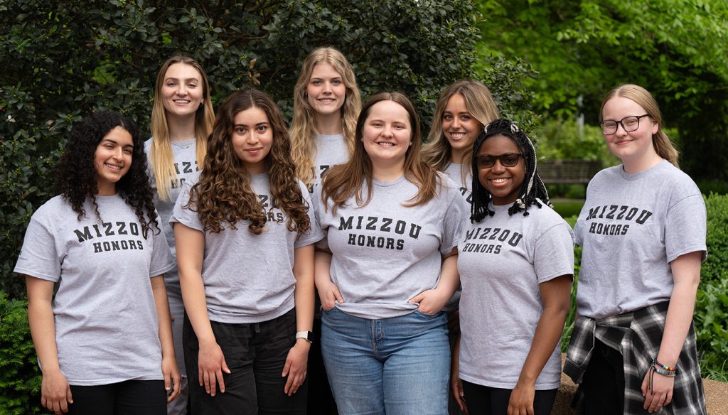 A group of students smiling while posing for a photo.