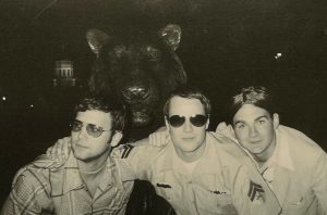 Three students smiling and posing for a picture.