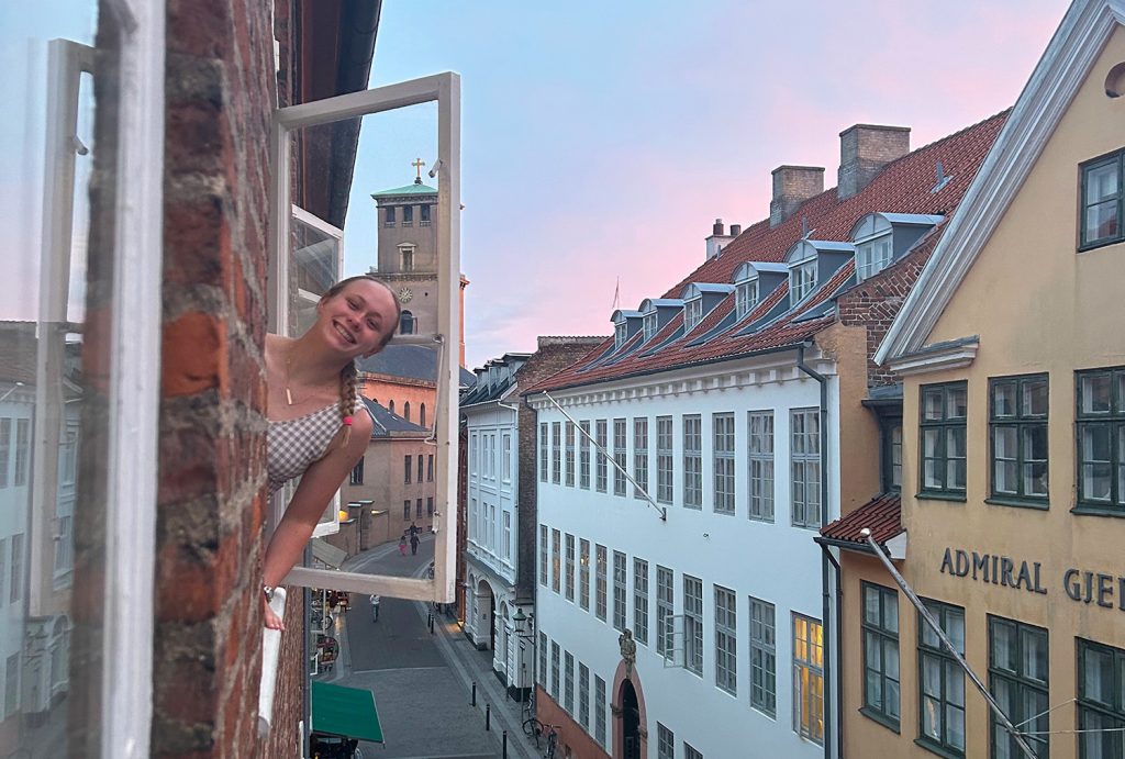 A student smiling while posing for a picture during a study abroad experience.