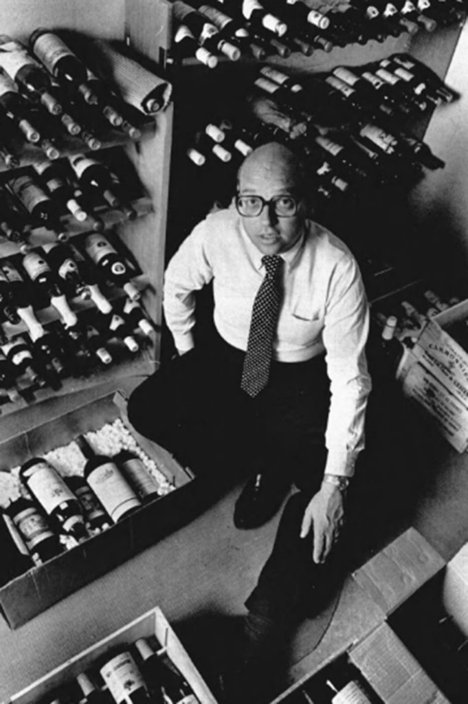 Bill Bondeson sitting in front of multiple bottles.