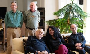 Five individuals smiling while posing for a picture.