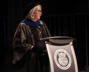 Carolyn Orbann speaking during a commencement ceremony.