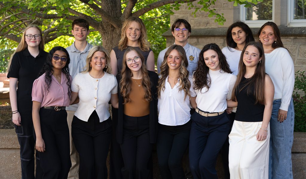 A group of students smiling while posing for a photo.