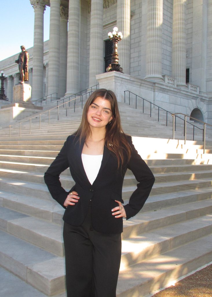 Anna Boyle posing for a photo in front of the Missouri Capitol building.