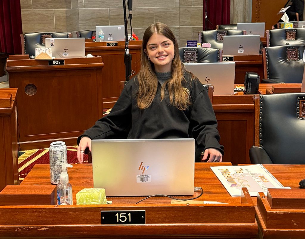 Anna Boyle posing for a photo while sitting.