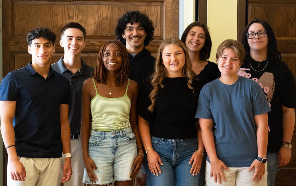 A group of several students smiling while posing for a photo.
