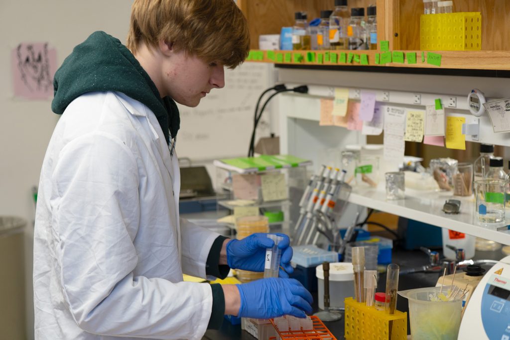 Archer Stone performing a research task in a research laboratory.