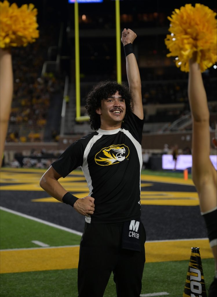 Izayah Christopher cheering during a football game.
