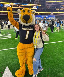 Morgan Williams smiling while posing for a photo with Truman the Tiger.