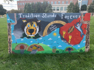 A banner is emblazoned with the MU Homecoming 2019 theme “Tradition Stands Forever.”