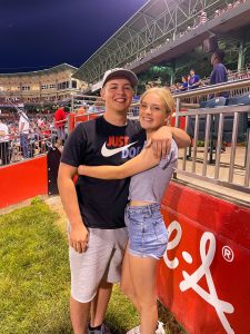 Cade McKnelly and friend pose at a sports stadium
